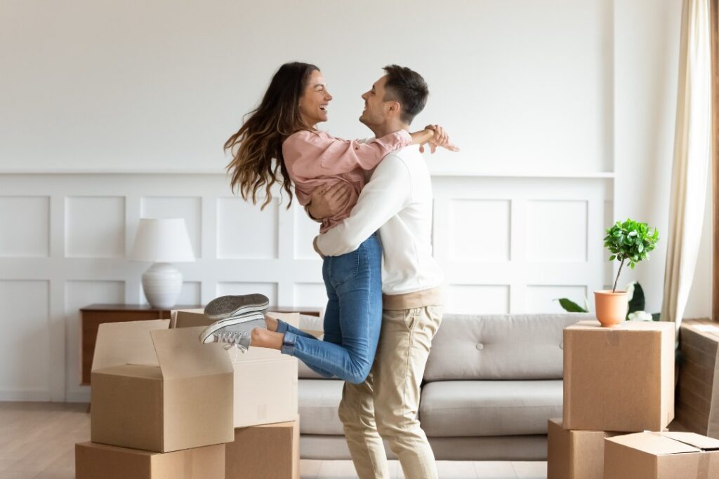 The couple hugs each other happily because of Apartment Moving.