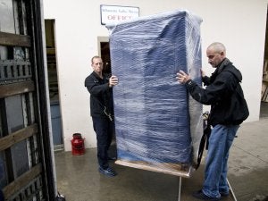 Two workers moving the shipments, Portland OR